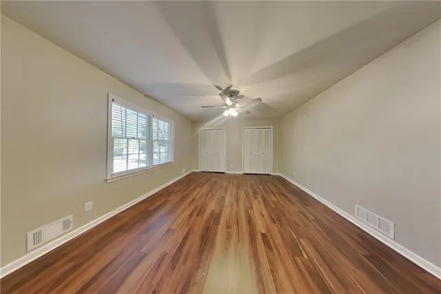 wooden floor in an empty room with a window