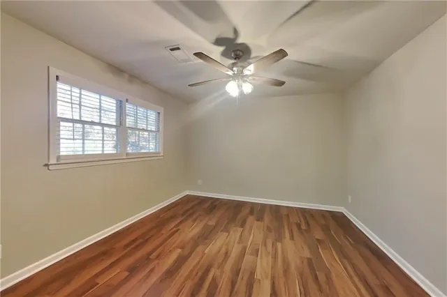 wooden floor in an empty room with a window