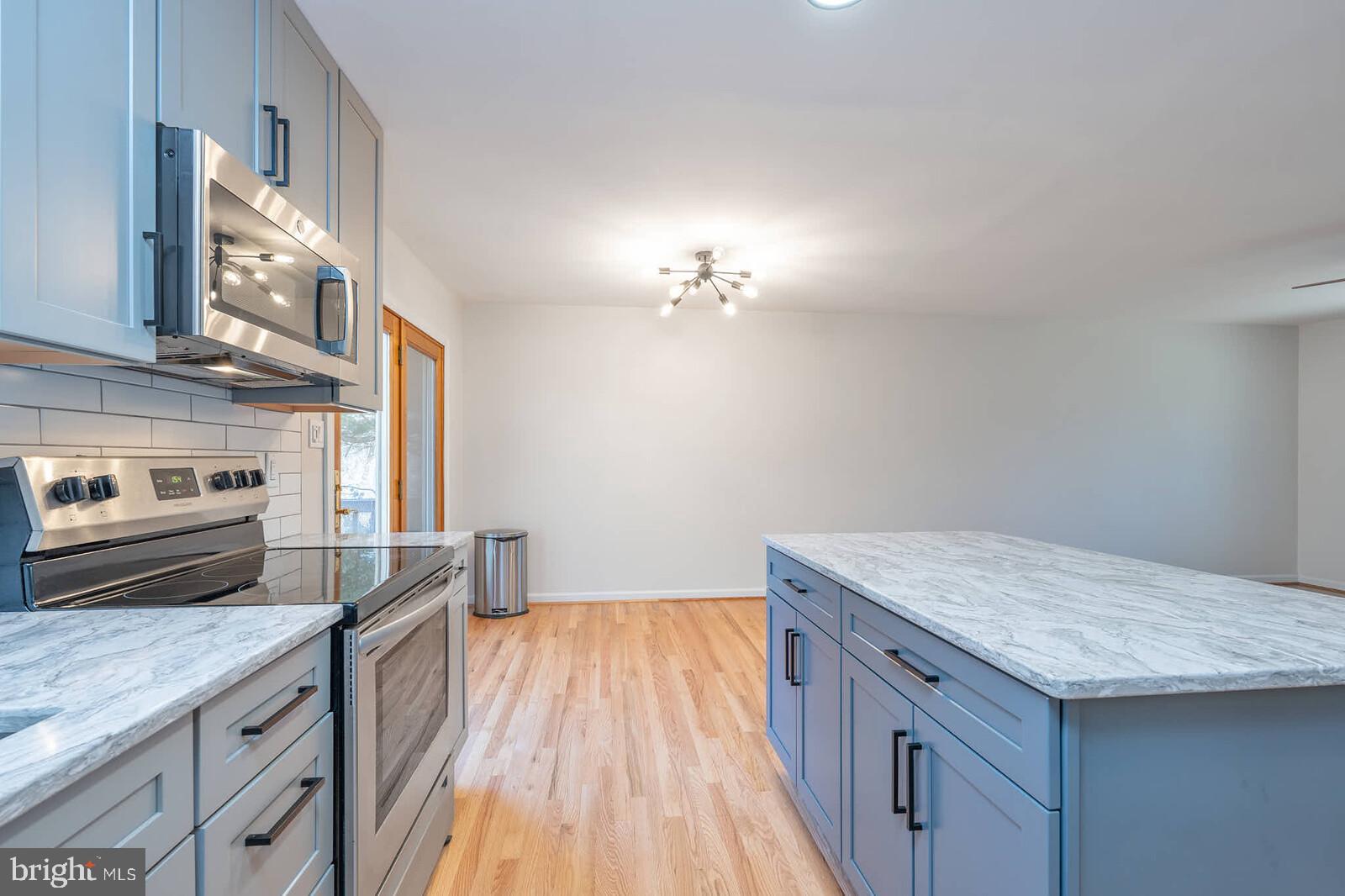 4921 Buffalo Road Mount Airy, MD 21771 - Photo 10 of 36 a kitchen with granite countertop a sink cabinets a counter top space and stainless steel appliances