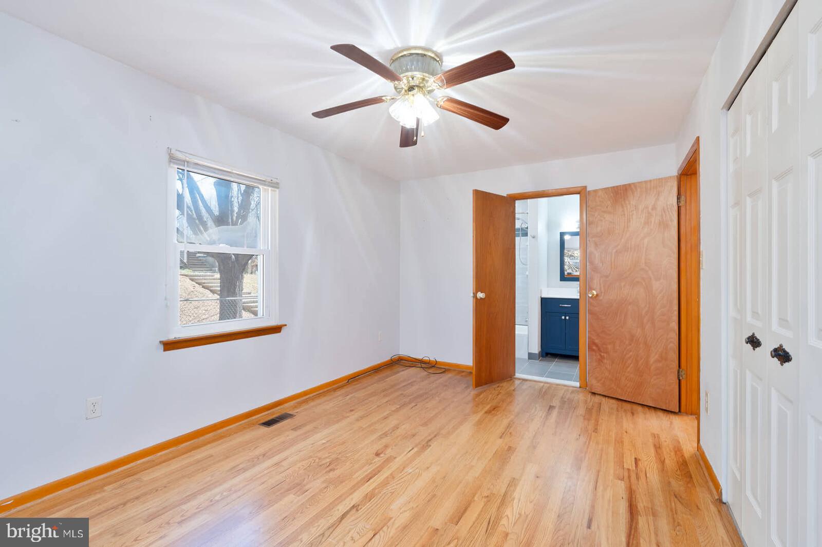 4921 Buffalo Road Mount Airy, MD 21771 - Photo 13 of 36 a view of an empty room with window and wooden floor