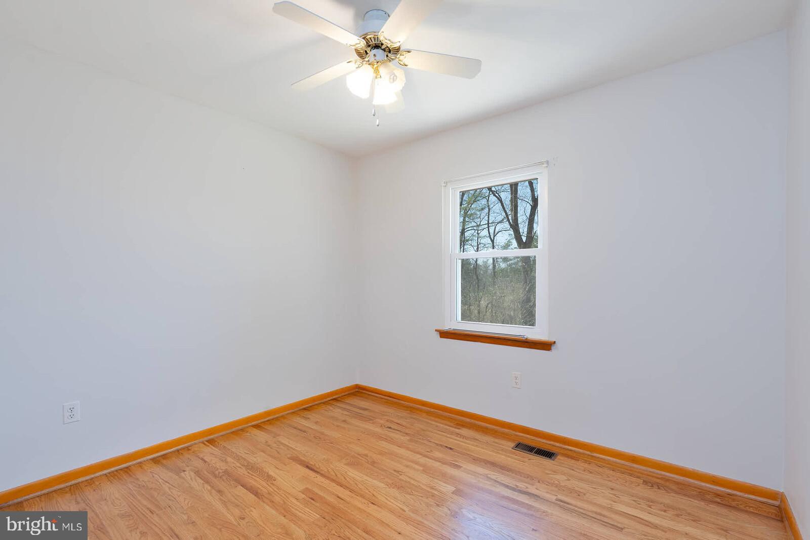 4921 Buffalo Road Mount Airy, MD 21771 - Photo 16 of 36 a view of an empty room with window and wooden floor