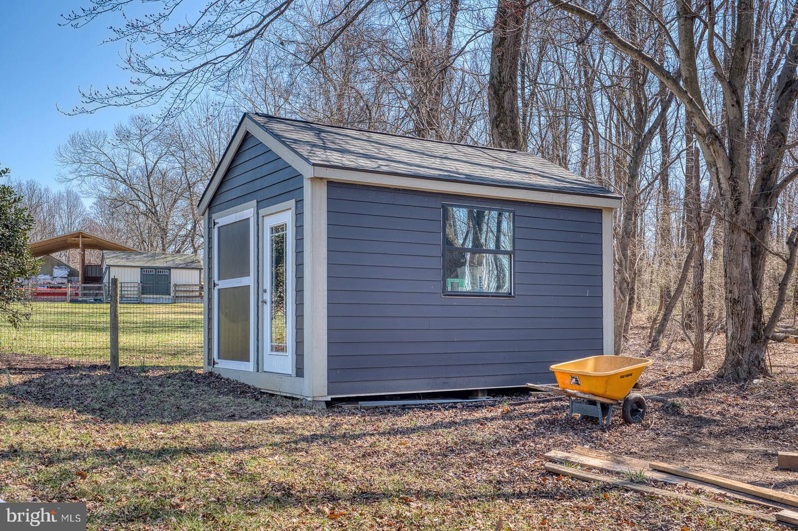 4921 Buffalo Road Mount Airy, MD 21771 - Photo 32 of 36 a view of a house with a backyard and a tree