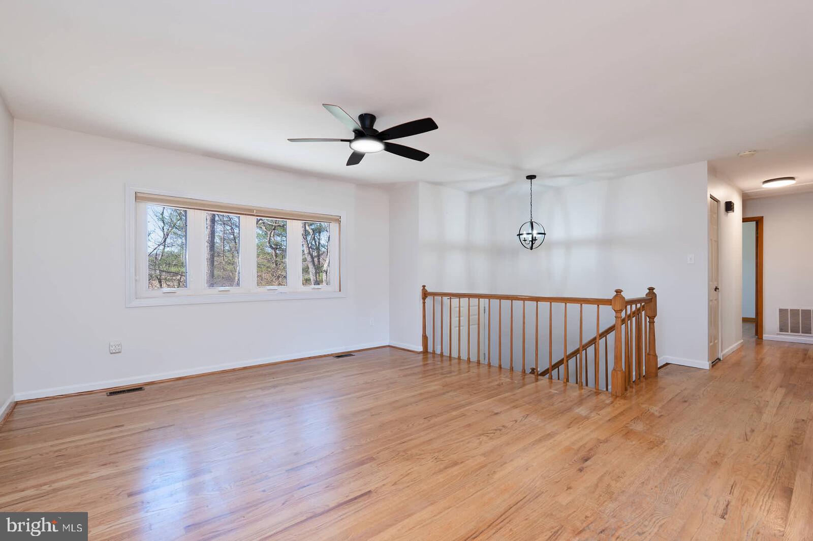 4921 Buffalo Road Mount Airy, MD 21771 - Photo 4 of 36 a view of an empty room with wooden floor and a window