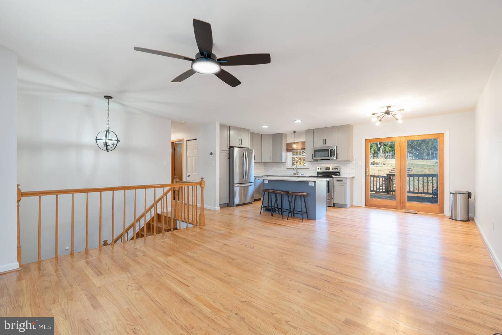 4921 Buffalo Road Mount Airy, MD 21771 - Photo 36 of 36 a view of an empty room and kitchen with wooden floor
