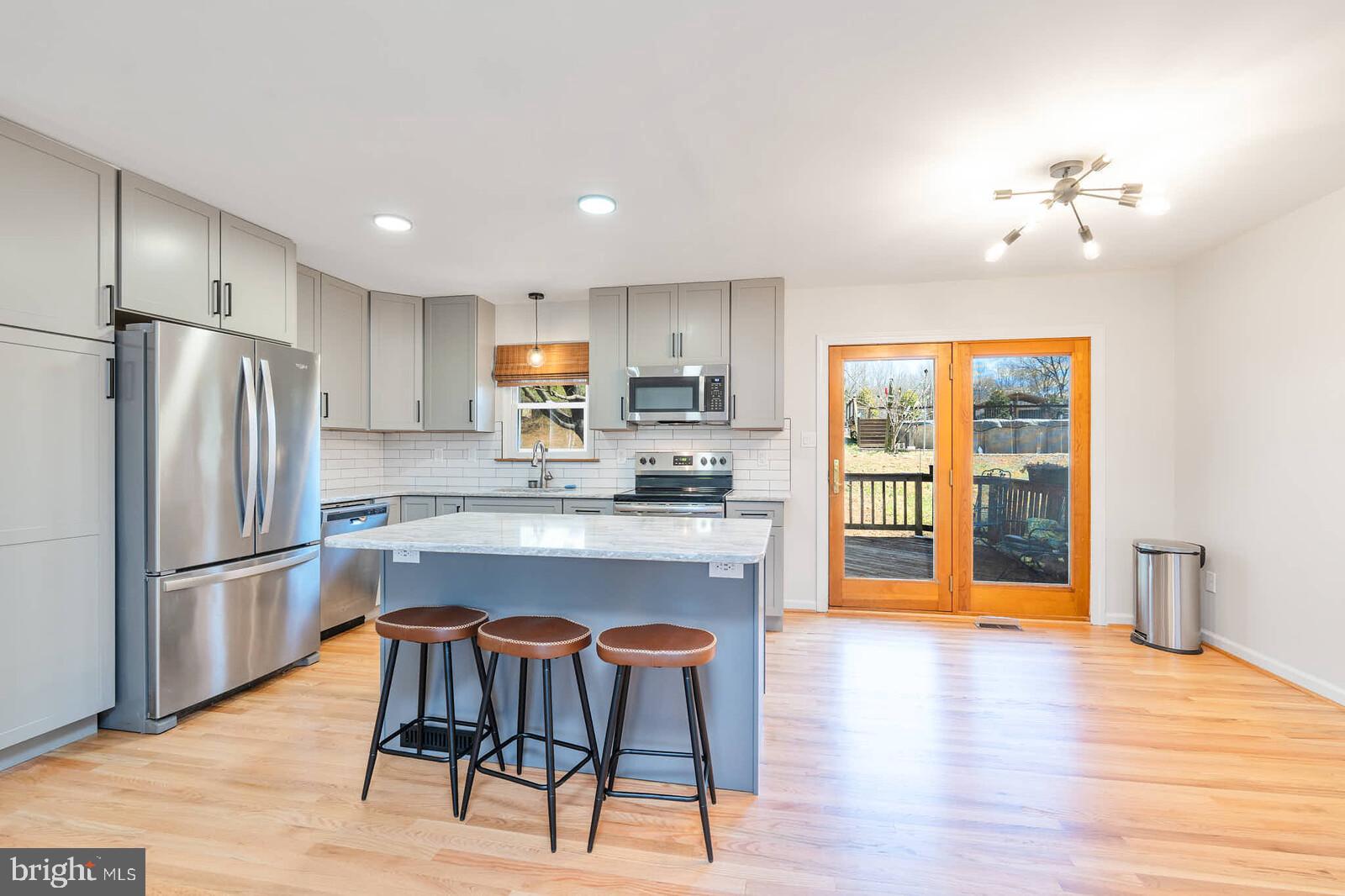 4921 Buffalo Road Mount Airy, MD 21771 - Photo 6 of 36 a kitchen with stainless steel appliances granite countertop a refrigerator and a stove top oven