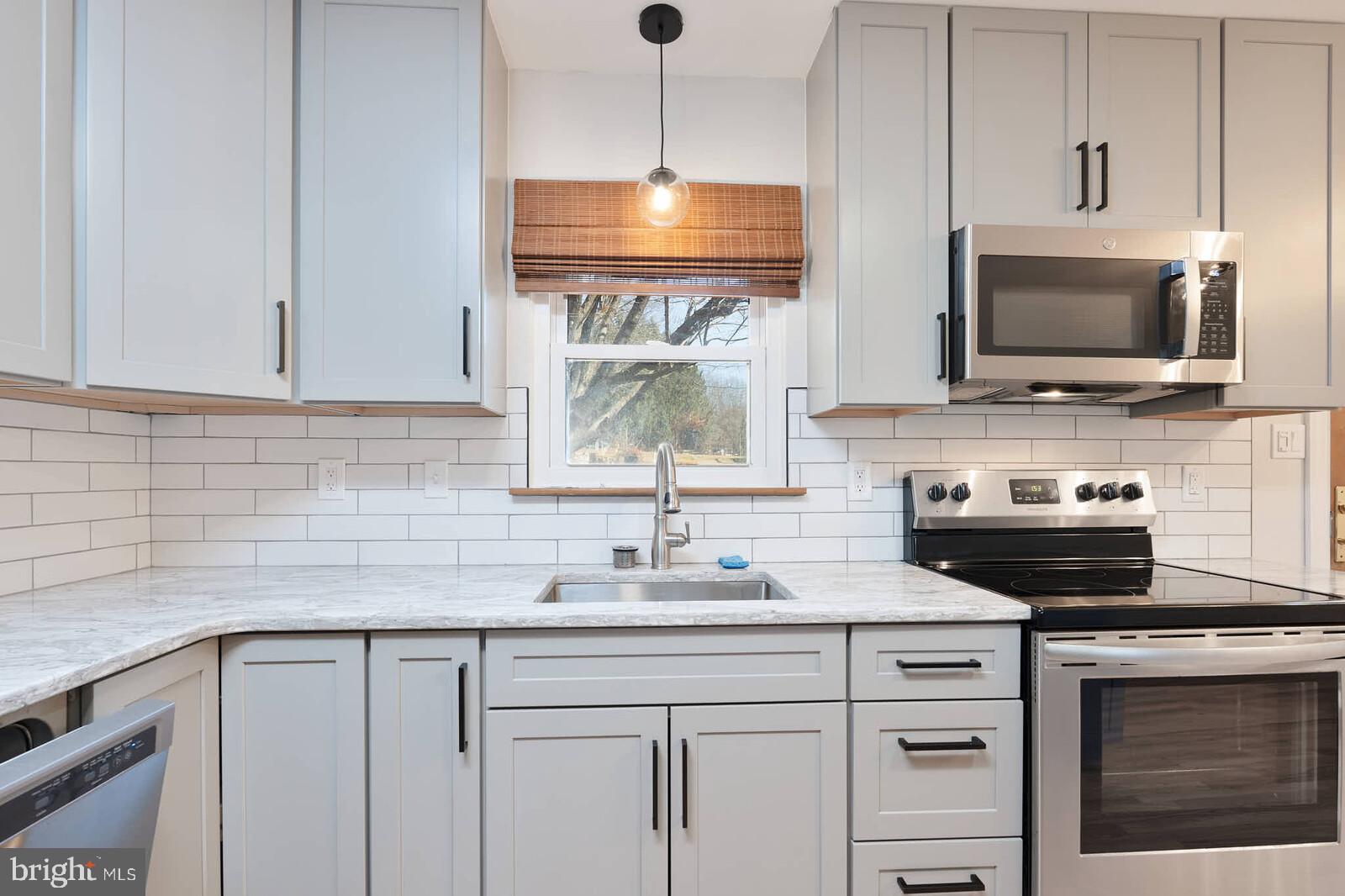 4921 Buffalo Road Mount Airy, MD 21771 - Photo 9 of 36 a kitchen with a sink stove and microwave