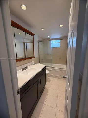 a view of a livingroom with a ceiling fan and window