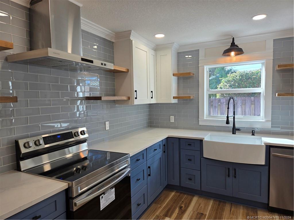 420 Southwest 7th Street Stuart, FL 34994 - Photo 1 of 17 a kitchen with a sink appliances cabinets and a window