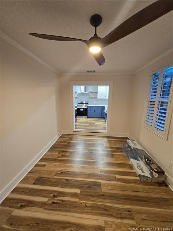 420 Southwest 7th Street Stuart, FL 34994 - Photo 11 of 17 a view of an empty room with wooden floor and chandelier
