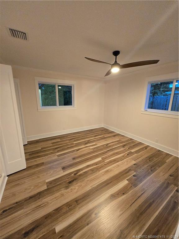 420 Southwest 7th Street Stuart, FL 34994 - Photo 15 of 17 a view of a livingroom with wooden floor and a ceiling fan