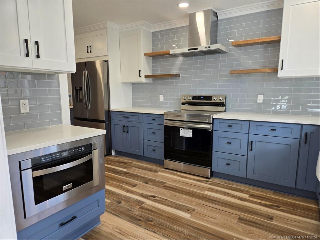 420 Southwest 7th Street Stuart, FL 34994 - Photo 2 of 17 a kitchen with stainless steel appliances granite countertop a stove and a refrigerator