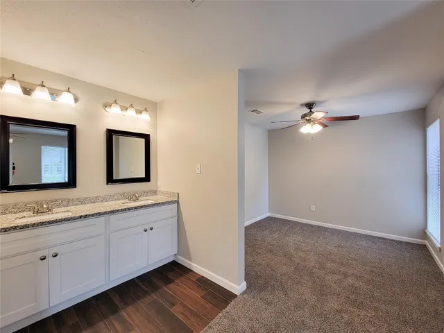 a bathroom with a double vanity sink and a mirror