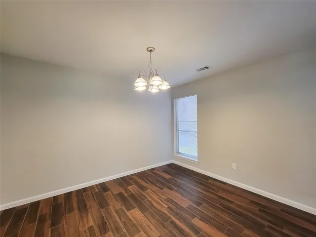 a view of wooden floor and chandelier in a room