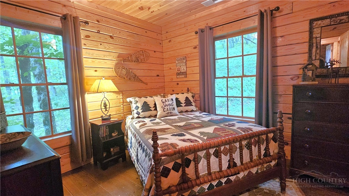 3043 Junaluska Road Boone, NC 28607 - Photo 22 of 49 a bedroom with a bed and a window