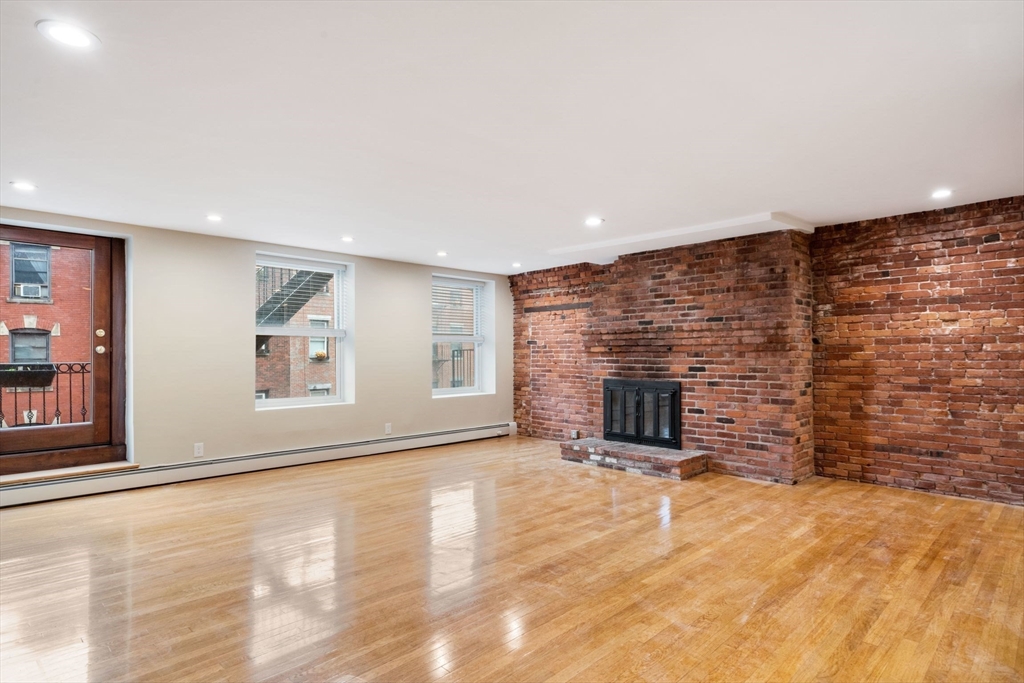130 Fulton Street, Unit 16 Boston, MA 02109 - Photo 5 of 22 a view of a livingroom with a fireplace