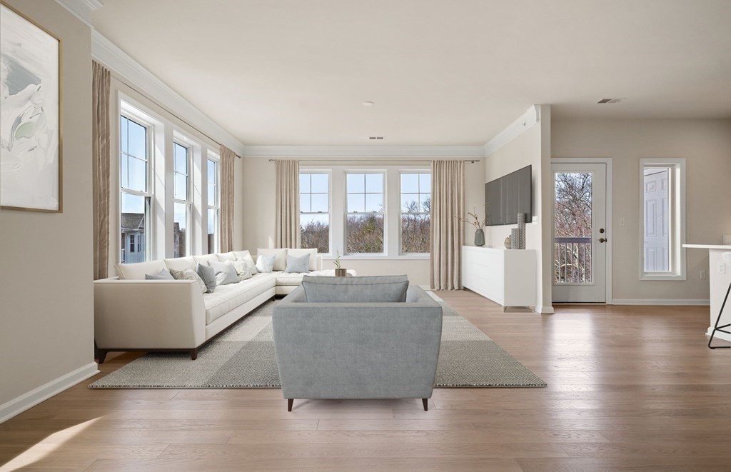 2 Stratton Drive, Unit 305 Woburn, MA 01801 - Photo 6 of 15 a living room with furniture and large windows