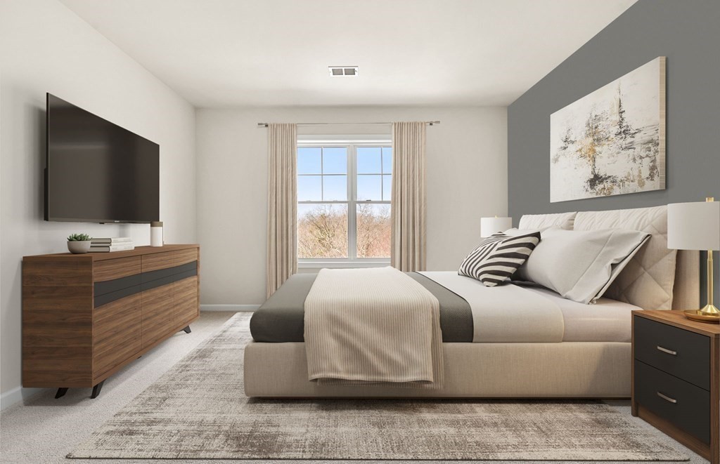 2 Stratton Drive, Unit 305 Woburn, MA 01801 - Photo 8 of 15 a bedroom with a bed and couch