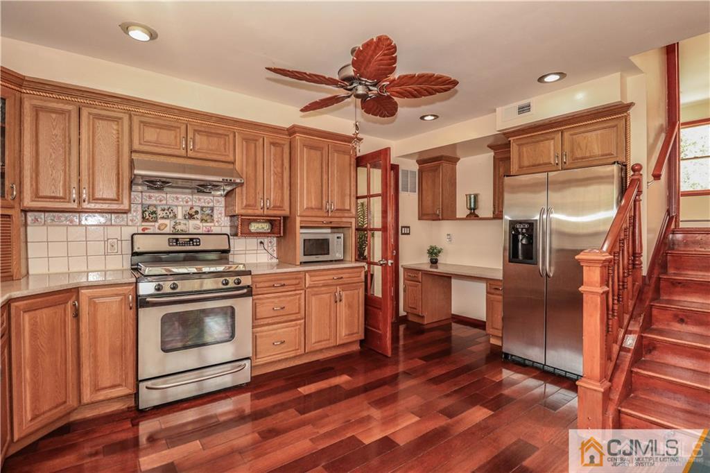 230 McFarlane Road Colonia, NJ 07067 - Photo 13 of 43 a kitchen with stainless steel appliances granite countertop a refrigerator a stove and a sink with cabinets