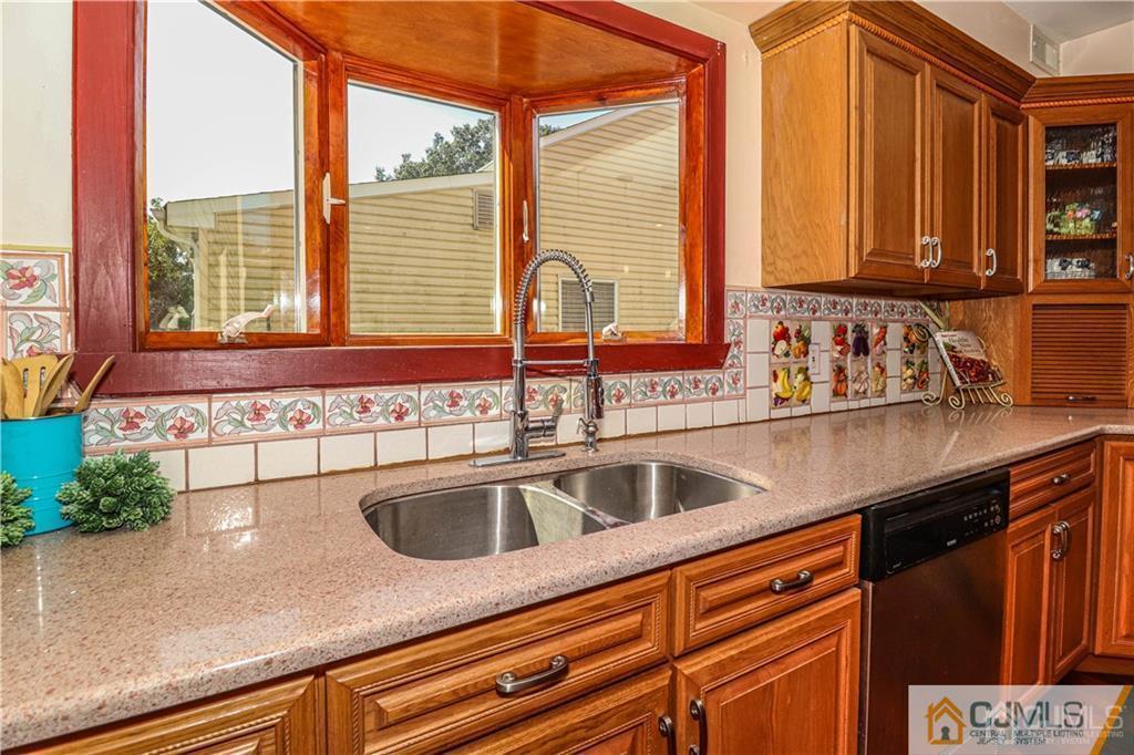 230 McFarlane Road Colonia, NJ 07067 - Photo 16 of 43 a kitchen with stainless steel appliances sink and large window