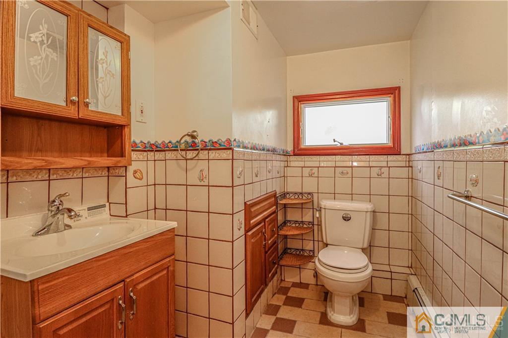 230 McFarlane Road Colonia, NJ 07067 - Photo 33 of 43 a bathroom with a toilet sink and mirror
