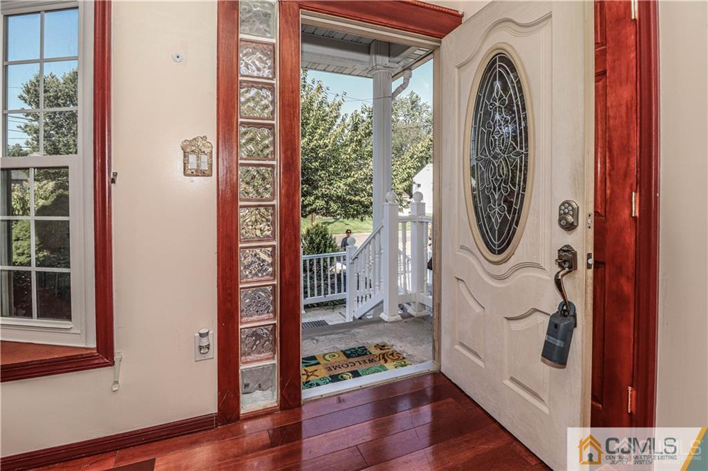230 McFarlane Road Colonia, NJ 07067 - Photo 5 of 43 a view of a hallway with wooden floor and windows