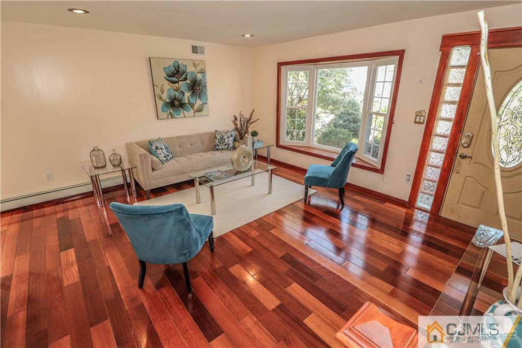 230 McFarlane Road Colonia, NJ 07067 - Photo 9 of 43 a living room with furniture and a wooden floor