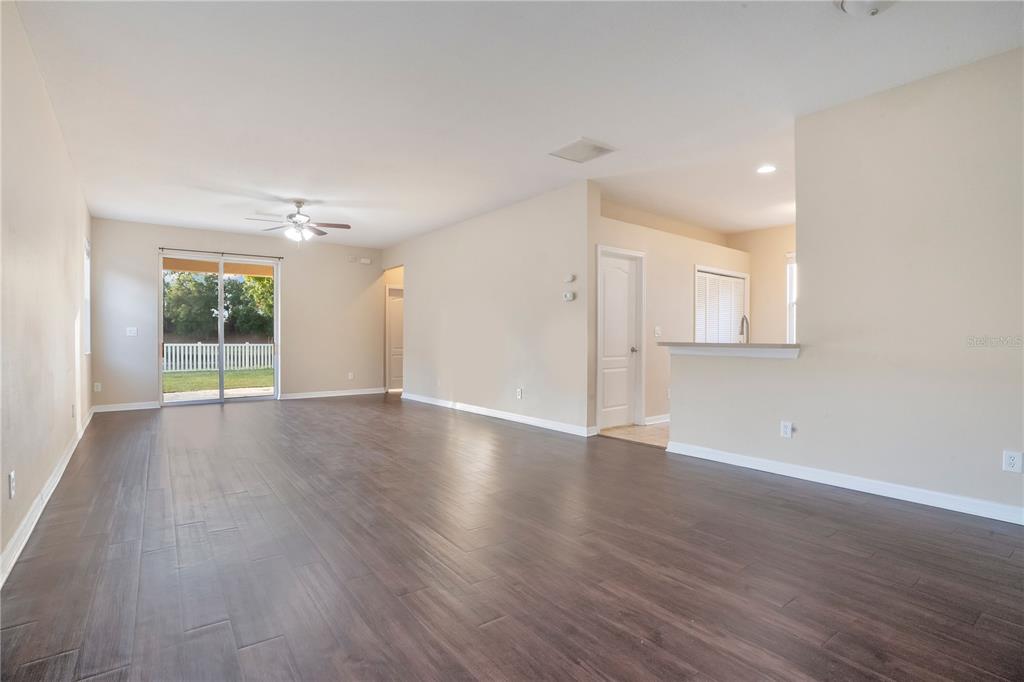 15031 Skip Jack Loop Lakewood Ranch, FL 34202 - Photo 18 of 27 an empty room with wooden floor and windows