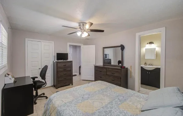 a bedroom with a bed and a desk