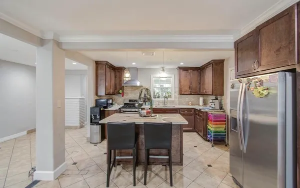 a kitchen with a sink and chairs