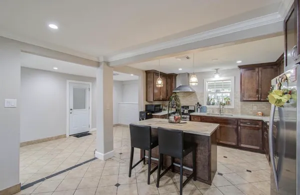 a kitchen with a sink stove top oven and cabinets