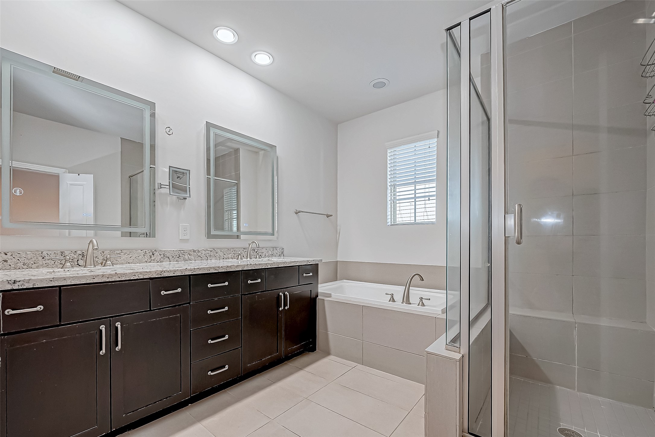2227 Chenevert Street Houston, TX 77003 - Photo 19 of 24 a bathroom with a granite countertop sink mirror and double