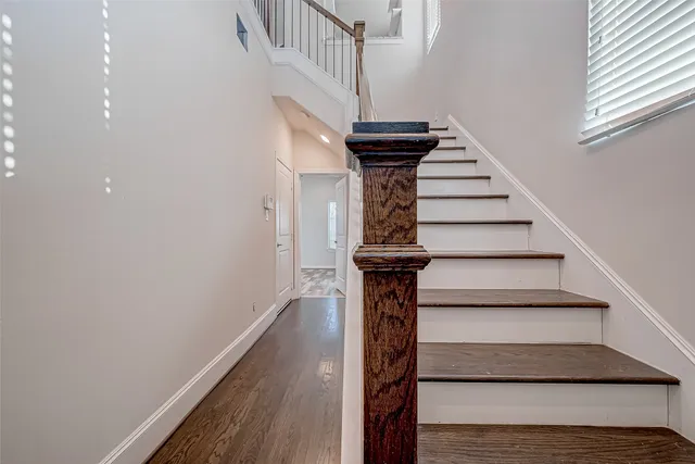 a view of entryway and gallery with wooden floor