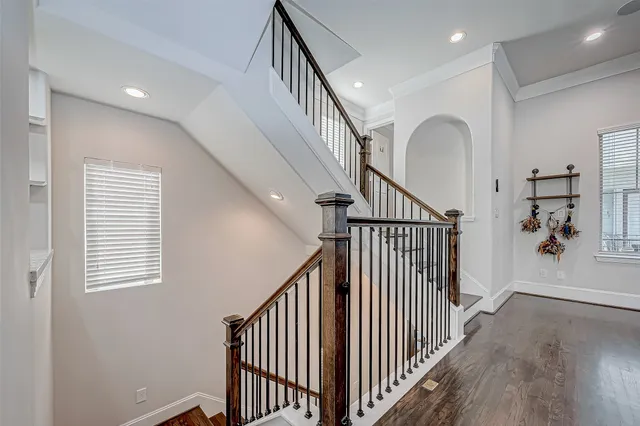 a view of a hallway with wooden floor and entryway