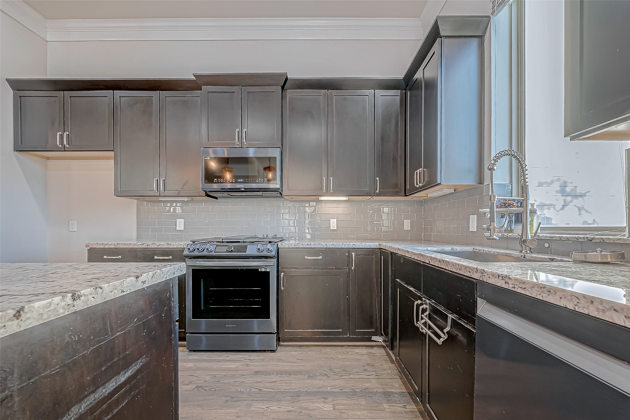 2227 Chenevert Street Houston, TX 77003 - Photo 7 of 24 a kitchen with stainless steel appliances granite countertop a sink and a stove top oven