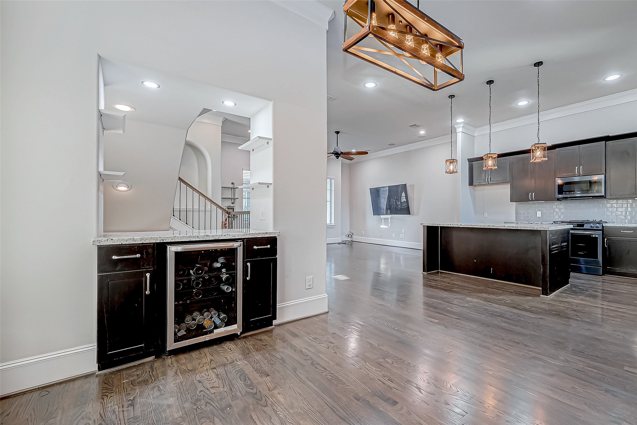 2227 Chenevert Street Houston, TX 77003 - Photo 10 of 24 a large kitchen with stainless steel appliances a large counter top a stove and a wooden floors