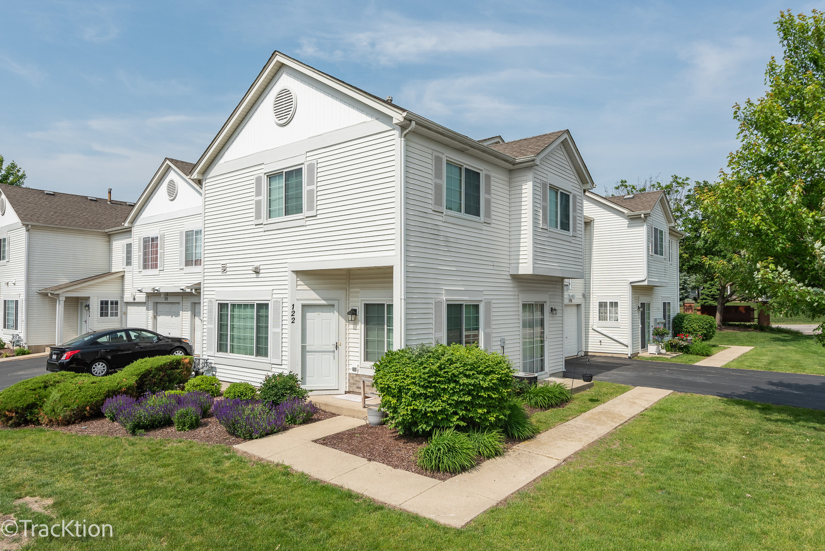 a front view of a house with a yard and outdoor seating
