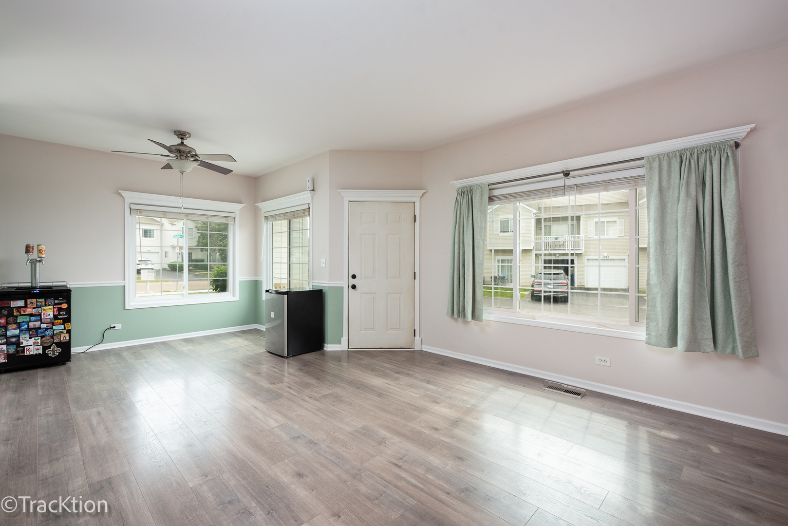 122 Creston Circle, Unit 122 Aurora, IL 60504 - Photo 3 of 22 a view of a livingroom with wooden floor and a ceiling fan