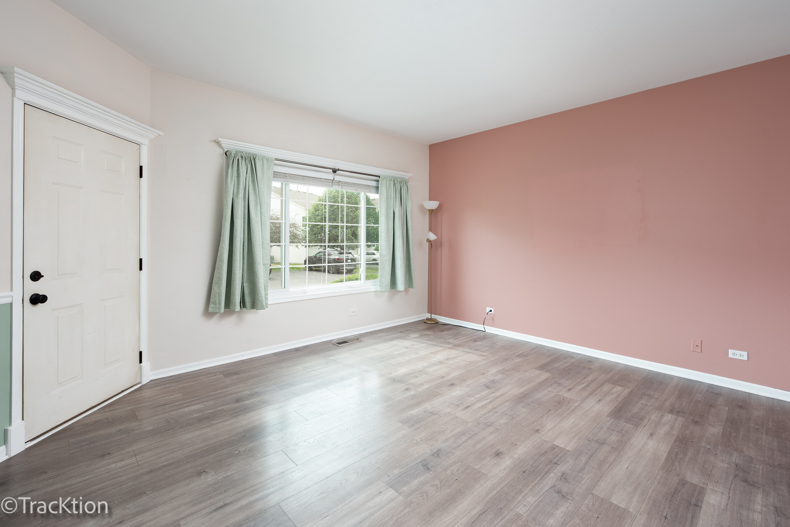 122 Creston Circle, Unit 122 Aurora, IL 60504 - Photo 4 of 22 a view of an empty room with wooden floor and a window