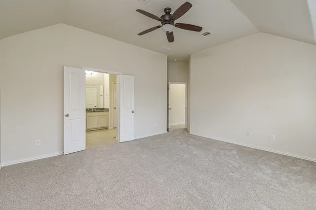 a bathroom with a granite countertop sink a mirror and a shower