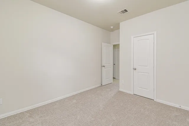 a bathroom with a granite countertop sink a toilet and a mirror