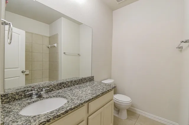 a large kitchen with kitchen island granite countertop a large counter top and wooden cabinets
