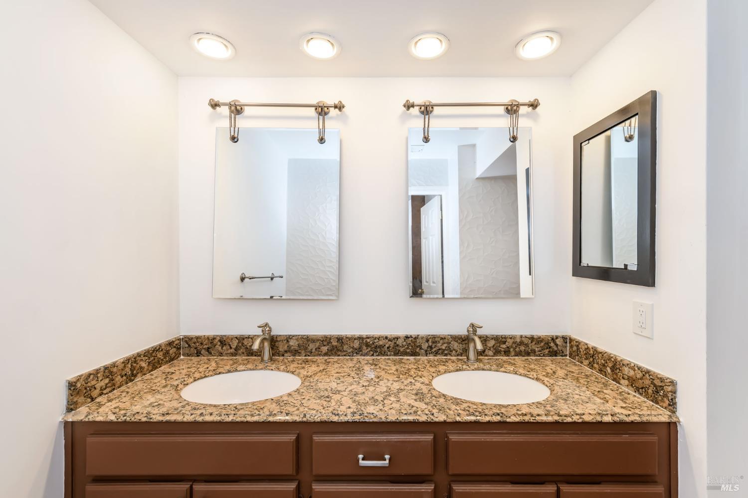 8 Mariners Circle San Rafael, CA 94903 - Photo 11 of 34 a bathroom with a granite countertop sink and a mirror