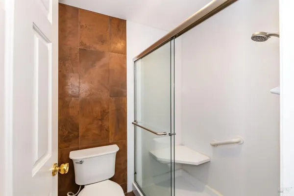 a bathroom with a toilet and a shower