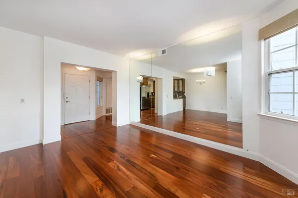 wooden floor in an empty room with a window