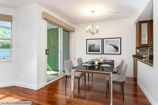 a kitchen with a table chairs refrigerator and cabinets