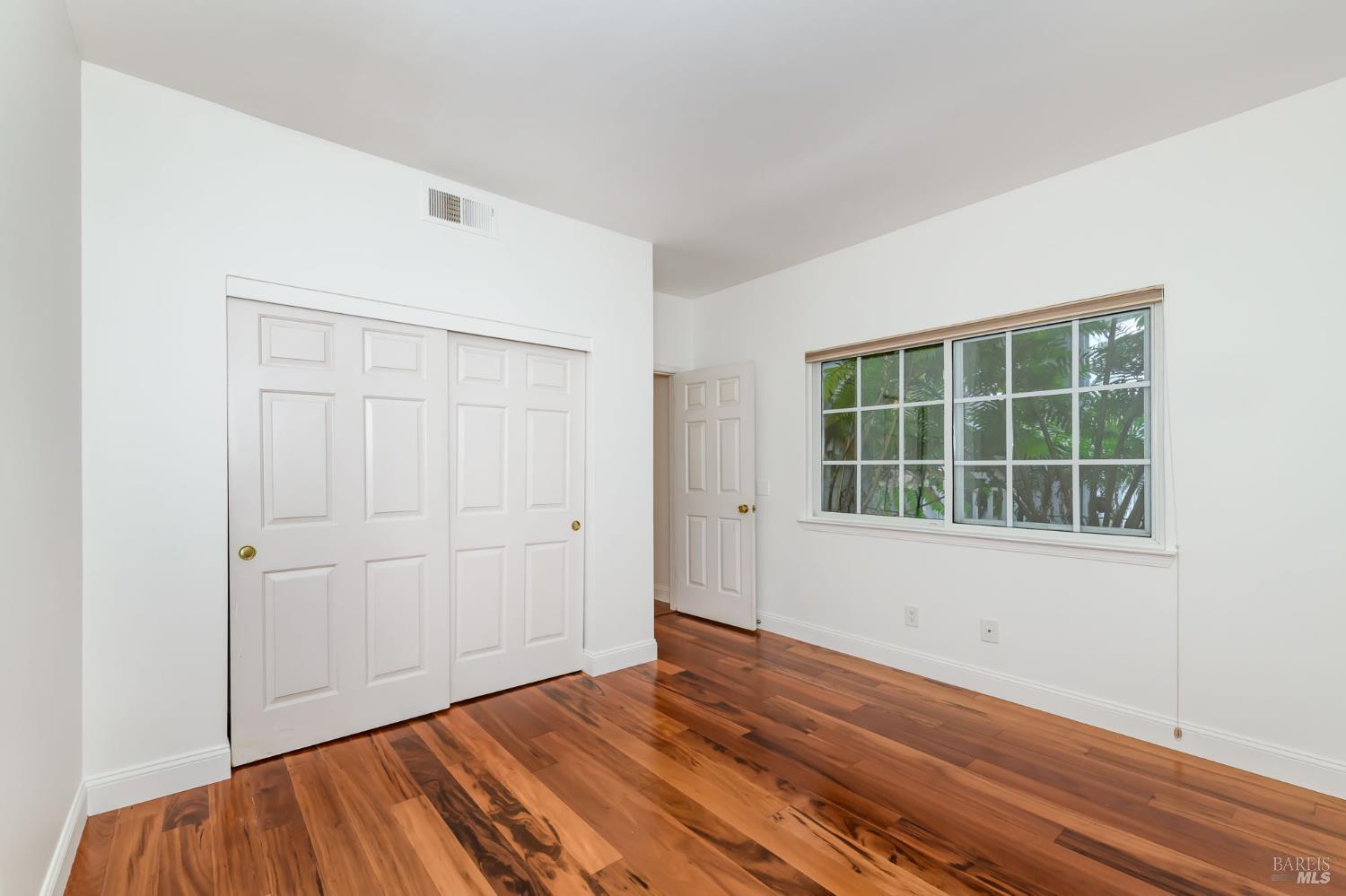 8 Mariners Circle San Rafael, CA 94903 - Photo 33 of 34 an empty room with wooden floor and windows