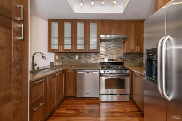 a kitchen with a stove a refrigerator and a sink