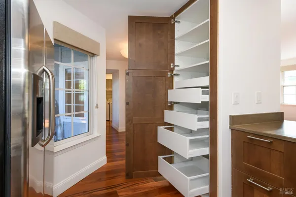 a view of walk in closet with empty racks