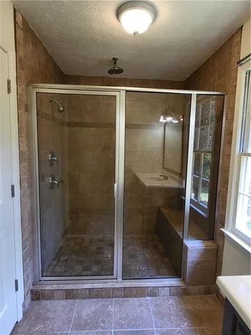 a bathroom with a glass shower door
