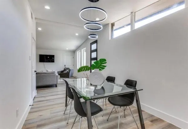 a view of a dining room with furniture and a potted plant